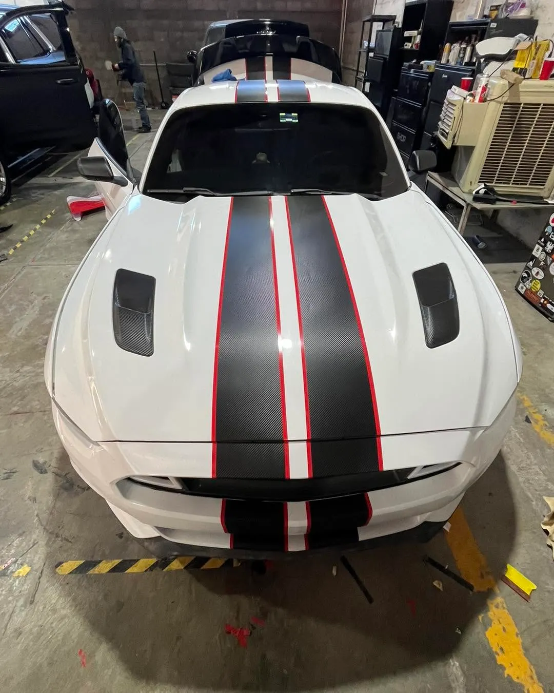 Ford Mustang blanco con franjas negras y rojas